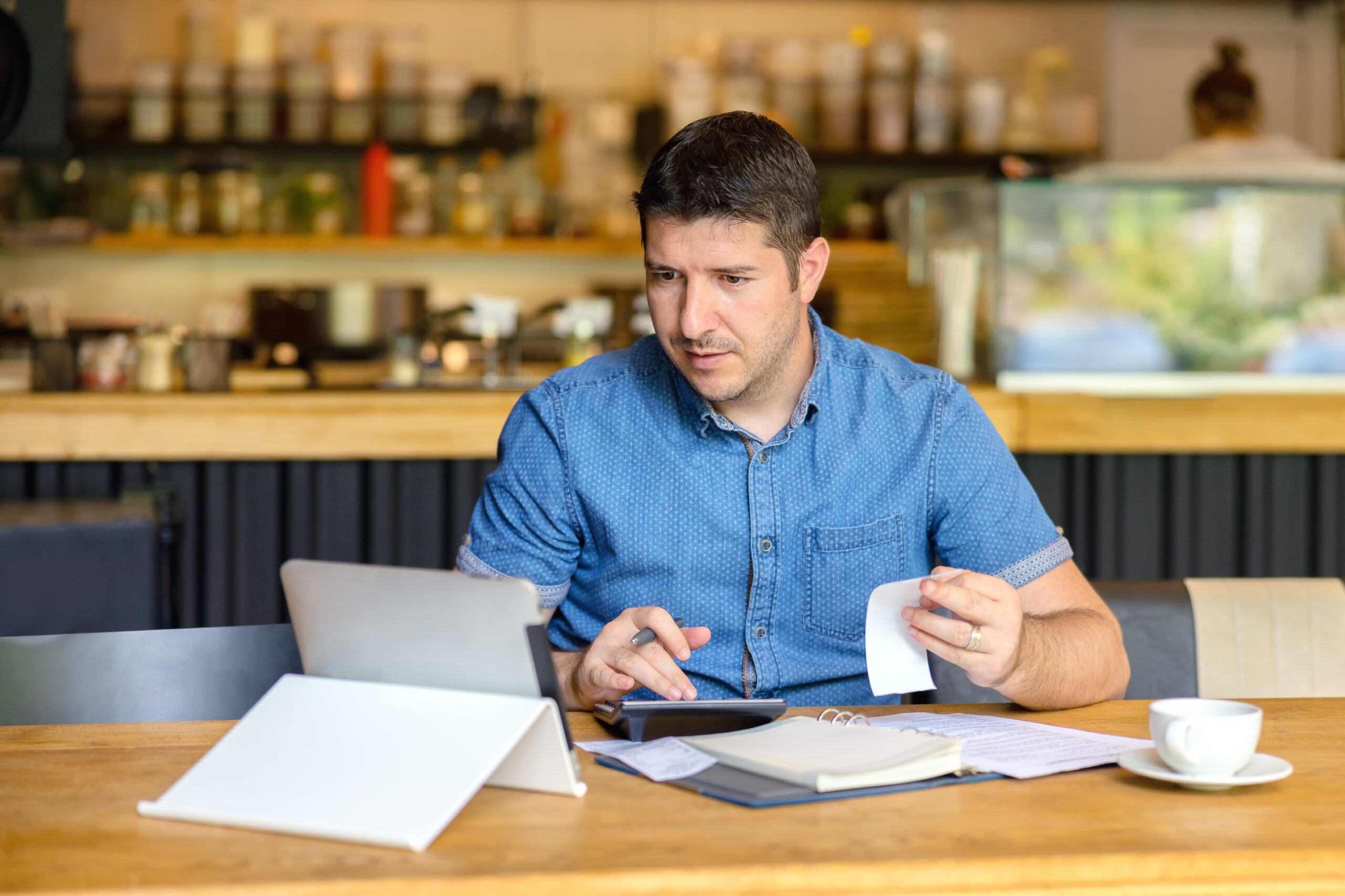 Mature,Restaurant,Owner,Calculating,Finance,And,Bills,Of,New,Business